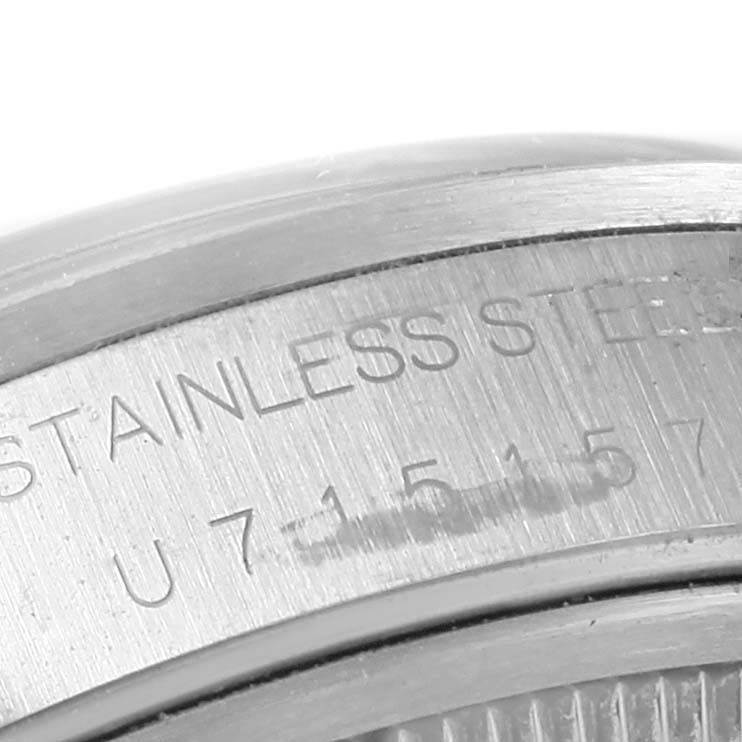 The image shows a close-up of the serial engraving on the stainless steel back of a Rolex Date 15200 Men's Stainless Steel Blue Dial 15200 Men's Stainless Steel Blue Dial model watch.
