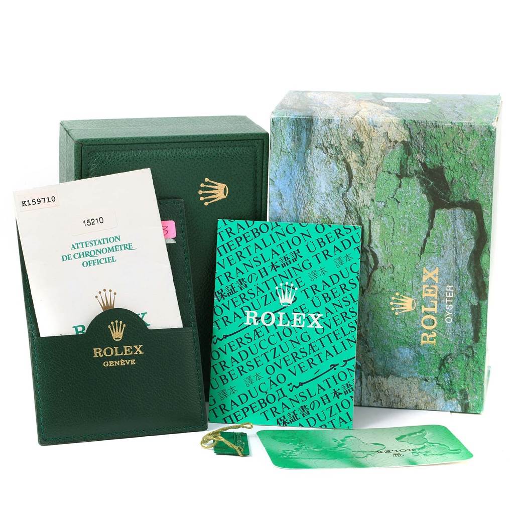 The image shows the packaging, manuals, warranty card, and booklets for a Rolex Date 15210 Men's Stainless Steel Black Dial 15210 Men's Stainless Steel Black Dial model watch, but not the watch itself.