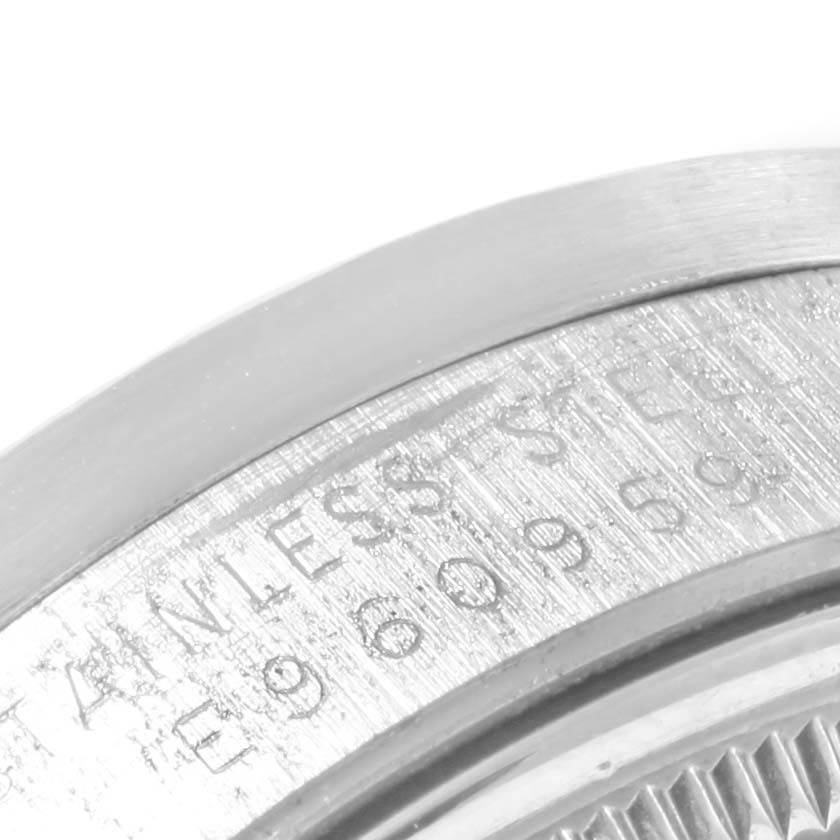 This close-up image shows the engraved rim of a Rolex Date 15210 Men's Stainless Steel Black Dial 15210 Men's Stainless Steel Black Dial model watch.