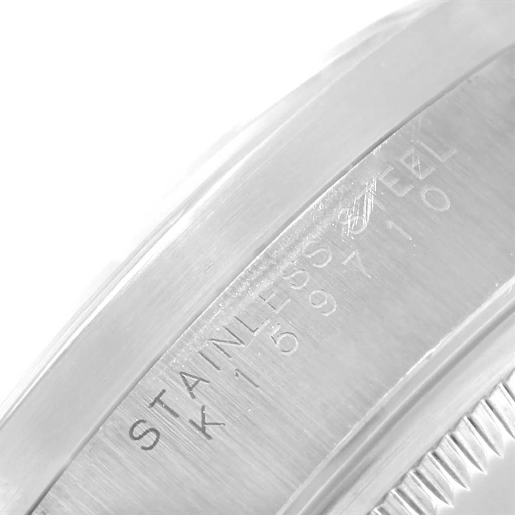 This close-up shows the side of a Rolex Date 15210 Men's Stainless Steel Silver Dial 15210 Men's Stainless Steel Silver Dial model’s stainless steel case, focusing on the engraved serial number.