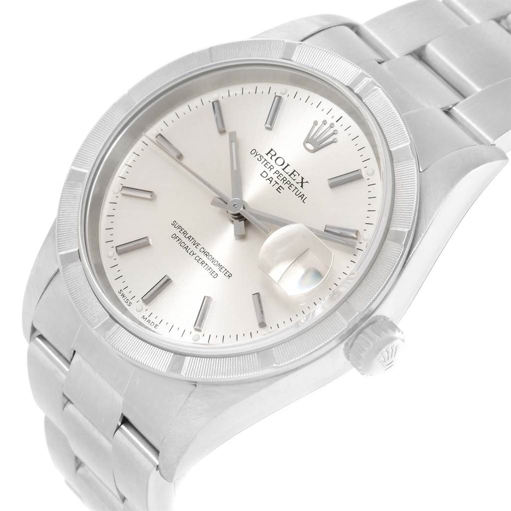 The image shows a Rolex Oyster Perpetual Date watch at an angle highlighting the dial, bezel, crown, and part of the bracelet.