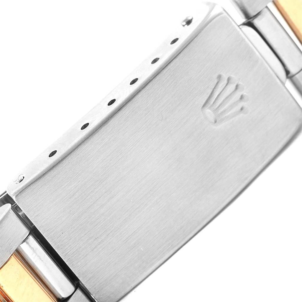This close-up image shows the clasp of a Rolex Date 15203 Men's Steel and Gold (two tone) Black Dial 15203 Men's Steel and Gold (two tone) Black Dial model watch, highlighting the logo and metal band detail.