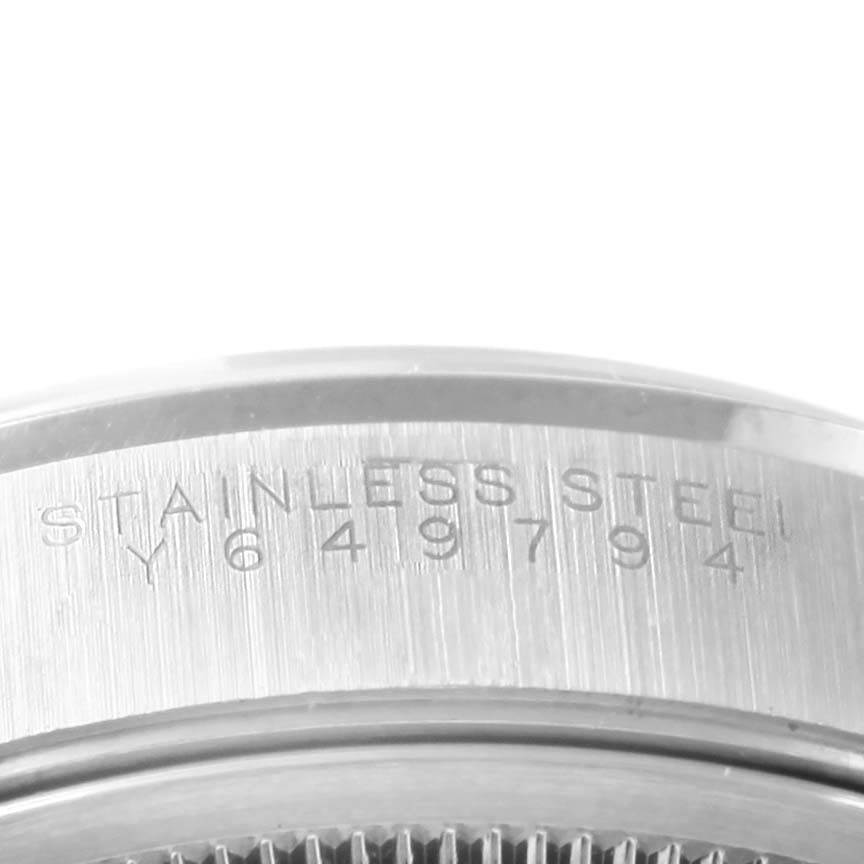 The image shows a close-up of the stainless steel serial number engraving on the side of a Rolex Date 15200 Men's Stainless Steel White Dial 15200 Men's Stainless Steel White Dial model watch.