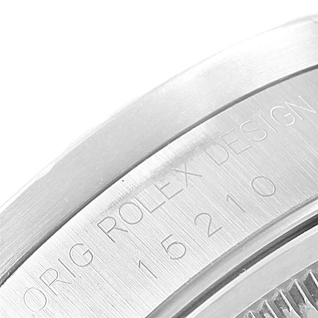 The image shows a close-up of the engraved bezel of a Rolex Date 15210 Men's Stainless Steel Grey Dial 15210 Men's Stainless Steel Grey Dial model.