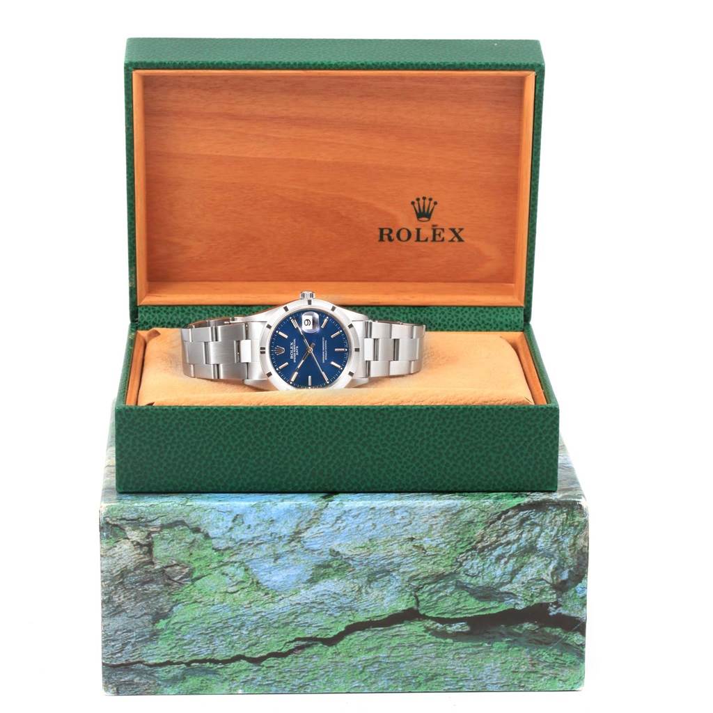 The image shows a Rolex Date 15210 Men's Stainless Steel Blue Dial 15210 Men's Stainless Steel Blue Dial model watch from a front angle, displayed in an open Rolex box.