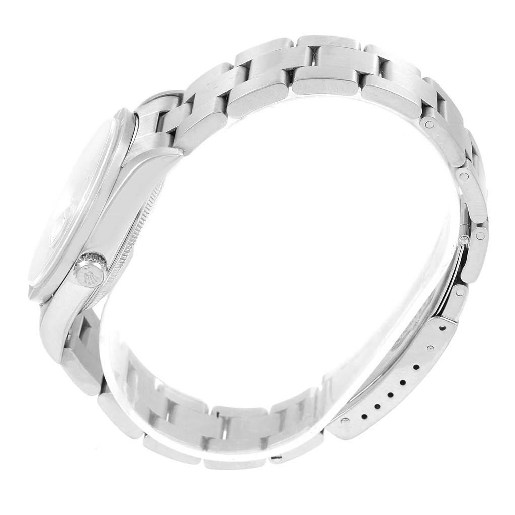 This side-angle view of the Rolex Date 15210 Men's Stainless Steel Blue Dial 15210 Men's Stainless Steel Blue Dial model shows the crown, case, and metal bracelet with its deployment clasp.