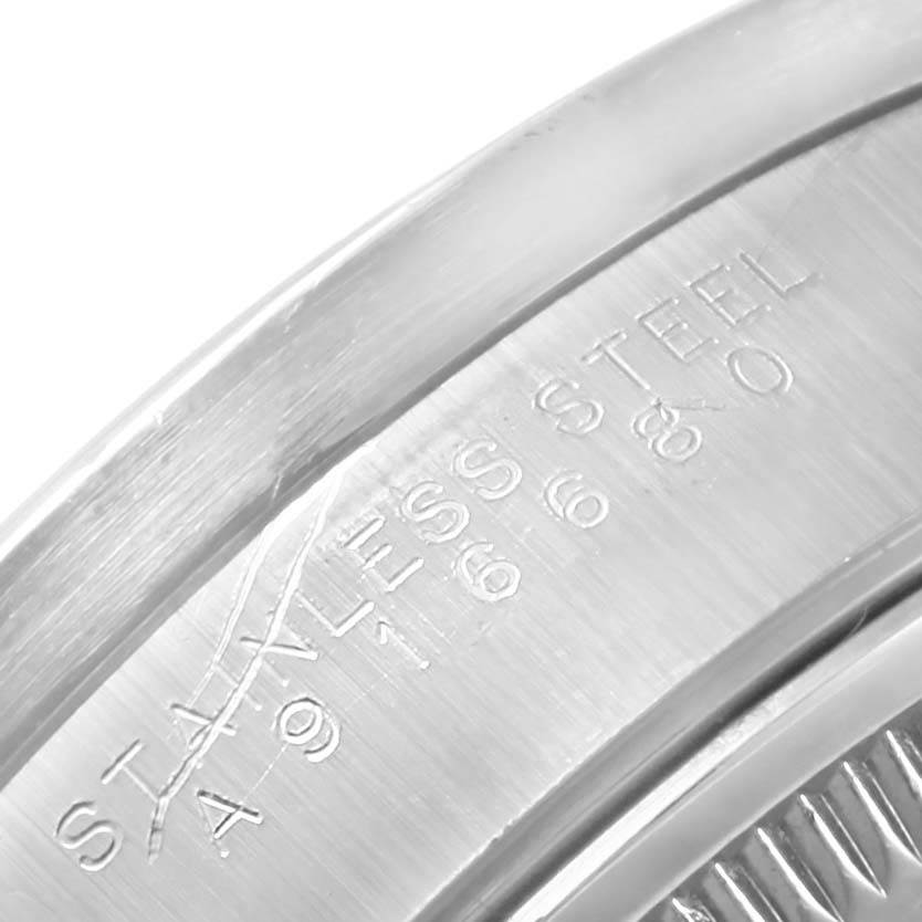 This is a close-up shot of the engraving on the stainless steel casing of a Rolex Date 15210 Men's Stainless Steel Blue Dial 15210 Men's Stainless Steel Blue Dial watch.