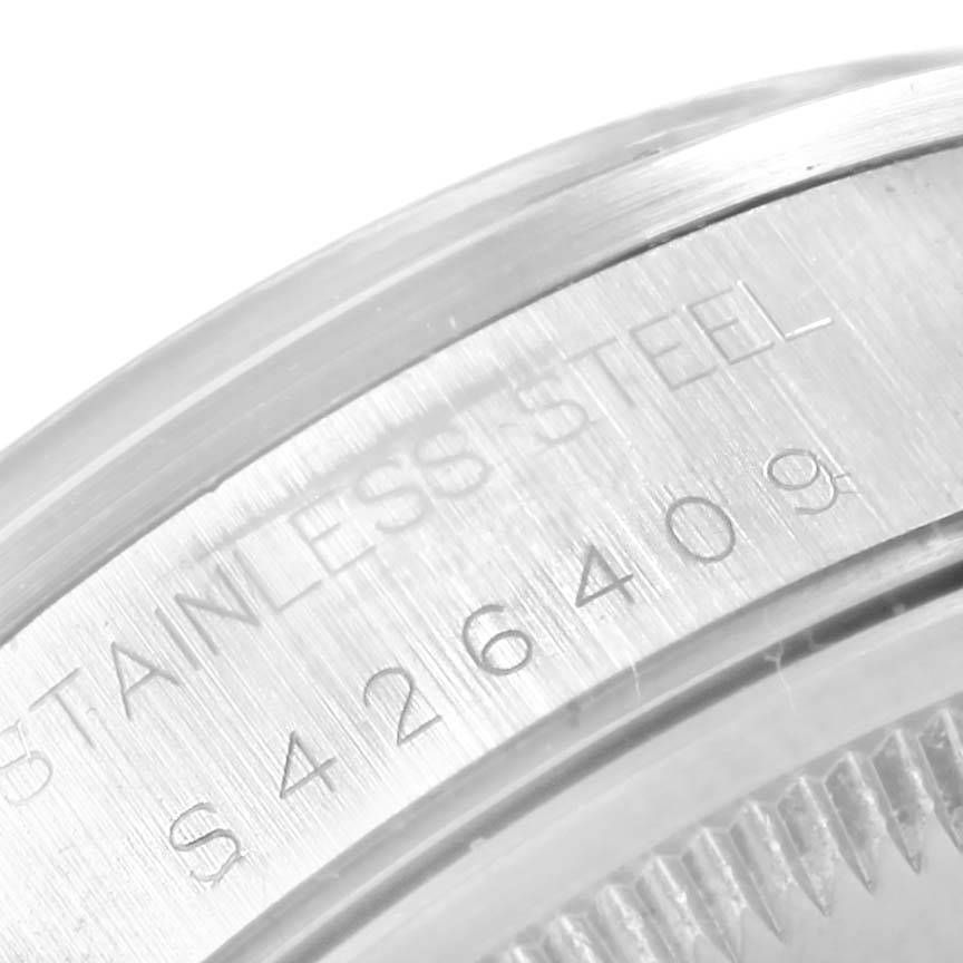 The image shows a close-up of the serial number and "Stainless Steel" engraving on the case of a Rolex Date 15200 Men's Stainless Steel Black Dial 15200 Men's Stainless Steel Black Dial model watch.