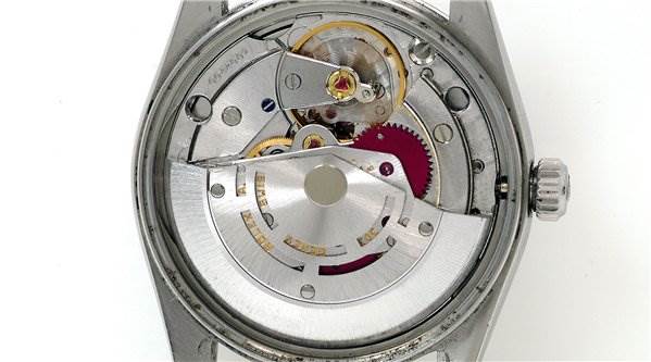 The image shows the internal mechanism and movement of a Rolex Date 15000 Men's Stainless Steel Purple Dial 15000 Men's Stainless Steel Purple Dial model watch with the back cover removed.