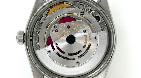 This image shows the internal mechanical movement of a Rolex Date 15000 Men's Stainless Steel Purple Dial 15000 Men's Stainless Steel Purple Dial model watch from the back.