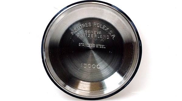 This image shows the inner case back of a Rolex Date 15000 Men's Stainless Steel Purple Dial 15000 Men's Stainless Steel Purple Dial model watch, displaying brand markings and model number 15000.