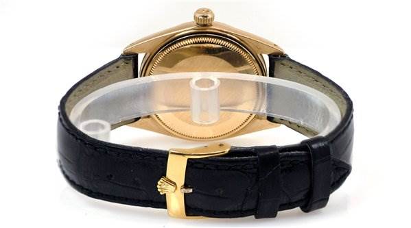 The image shows the back view and the leather strap with the clasp of a Rolex Date 1503 Men's Yellow Gold Black Dial 1503 Men's Yellow Gold Black Dial watch.