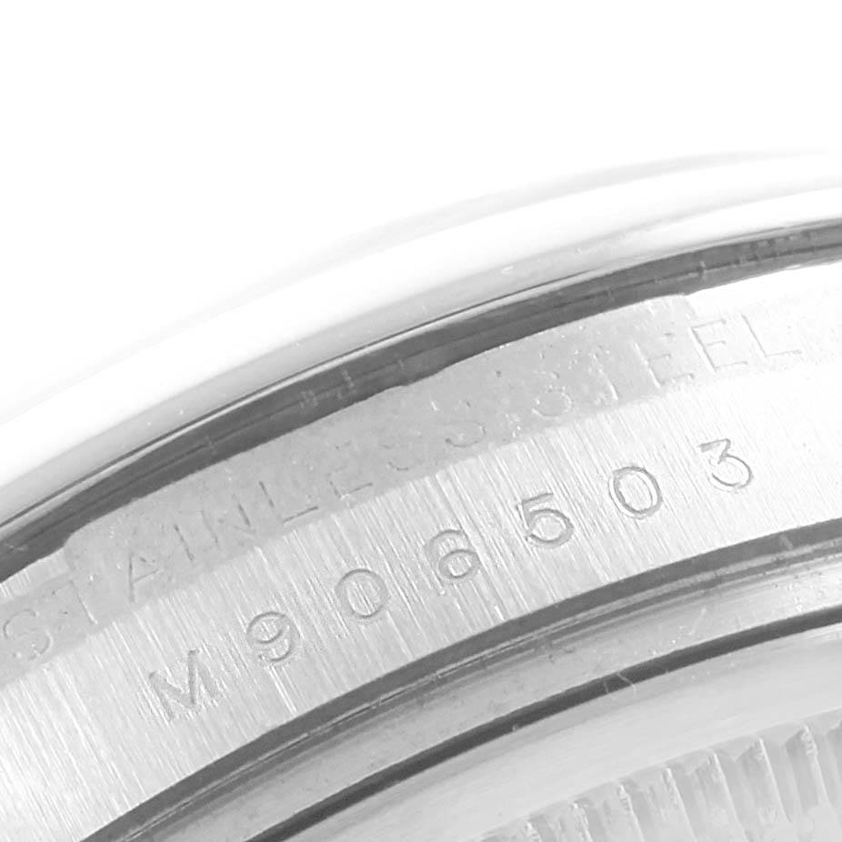 This image shows a close-up view of the case back edge of a Rolex Date 115200 Men's Stainless Steel Black Dial 115200 Men's Stainless Steel Black Dial model, highlighting the stainless steel markings and serial number.