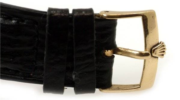 The image shows the clasp side of the strap of a Date model Rolex watch.