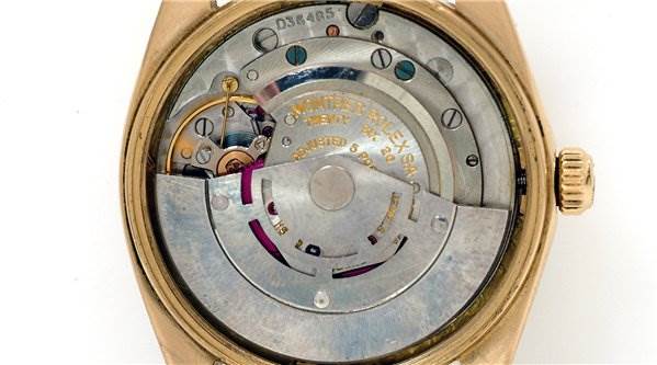 This image shows the internal mechanical movement of a Rolex Date 1503 Men's Yellow Gold Champagne Dial 1503 Men's Yellow Gold Champagne Dial model watch with its case back removed, exposing the rotor and gears.