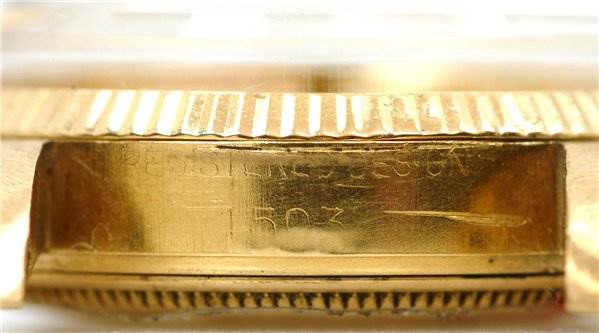 This close-up image of a Rolex Date 1503 Men's Yellow Gold Champagne Dial 1503 Men's Yellow Gold Champagne Dial model watch shows the case side and the reference number engravings.