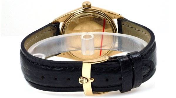 The image shows the back case and leather strap of a Rolex Date 1503 Men's Yellow Gold Champagne Dial 1503 Men's Yellow Gold Champagne Dial model watch.