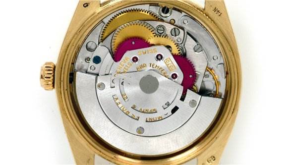 The image shows a close-up of the Rolex Date 1503 Men's Yellow Gold Champagne Dial 1503 Men's Yellow Gold Champagne Dial model watch's open case back, revealing its internal mechanical components.