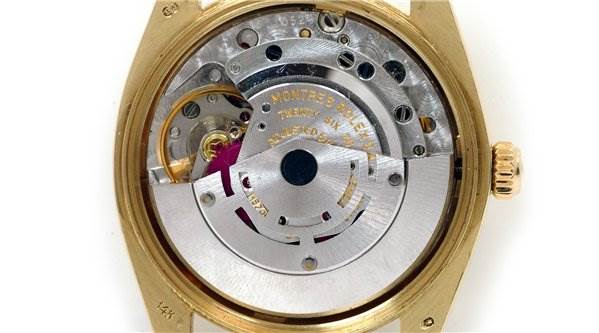 The image shows the inner mechanism and movement of a Rolex Date 1503 Men's Yellow Gold Champagne Dial 1503 Men's Yellow Gold Champagne Dial model watch.