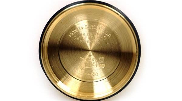 This is a top view showing the inside of the case back of a Rolex Date 1503 Men's Yellow Gold Champagne Dial 1503 Men's Yellow Gold Champagne Dial model watch.