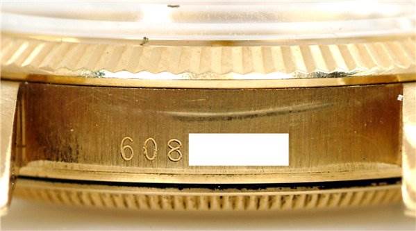 The image shows a close-up of the side of a Rolex Date 1503 Men's Yellow Gold Champagne Dial 1503 Men's Yellow Gold Champagne Dial model watch, highlighting the case and part of the bezel with engraved numbers.