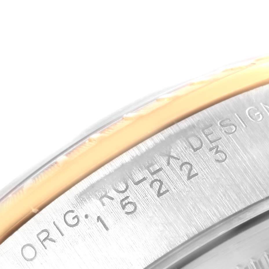 This close-up shows the edge and engraved serial number on the case of the Rolex Date 15223 Men's Steel and Gold (two tone) Black Dial 15223 Men's Steel and Gold (two tone) Black Dial model watch.