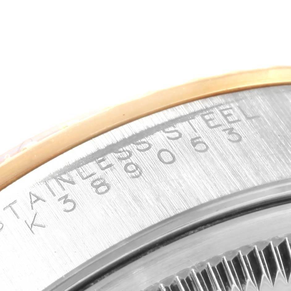 This image shows a close-up of the serial number and "Stainless Steel" text on the case of a Rolex Date 15223 Men's Steel and Gold (two tone) Black Dial 15223 Men's Steel and Gold (two tone) Black Dial model watch.