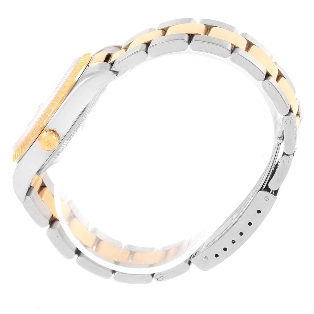 This side-angle view of the Rolex Date 15223 Men's Steel and Gold (two tone) Black Dial 15223 Men's Steel and Gold (two tone) Black Dial model watch showcases its crown, case, and two-tone Oyster bracelet.