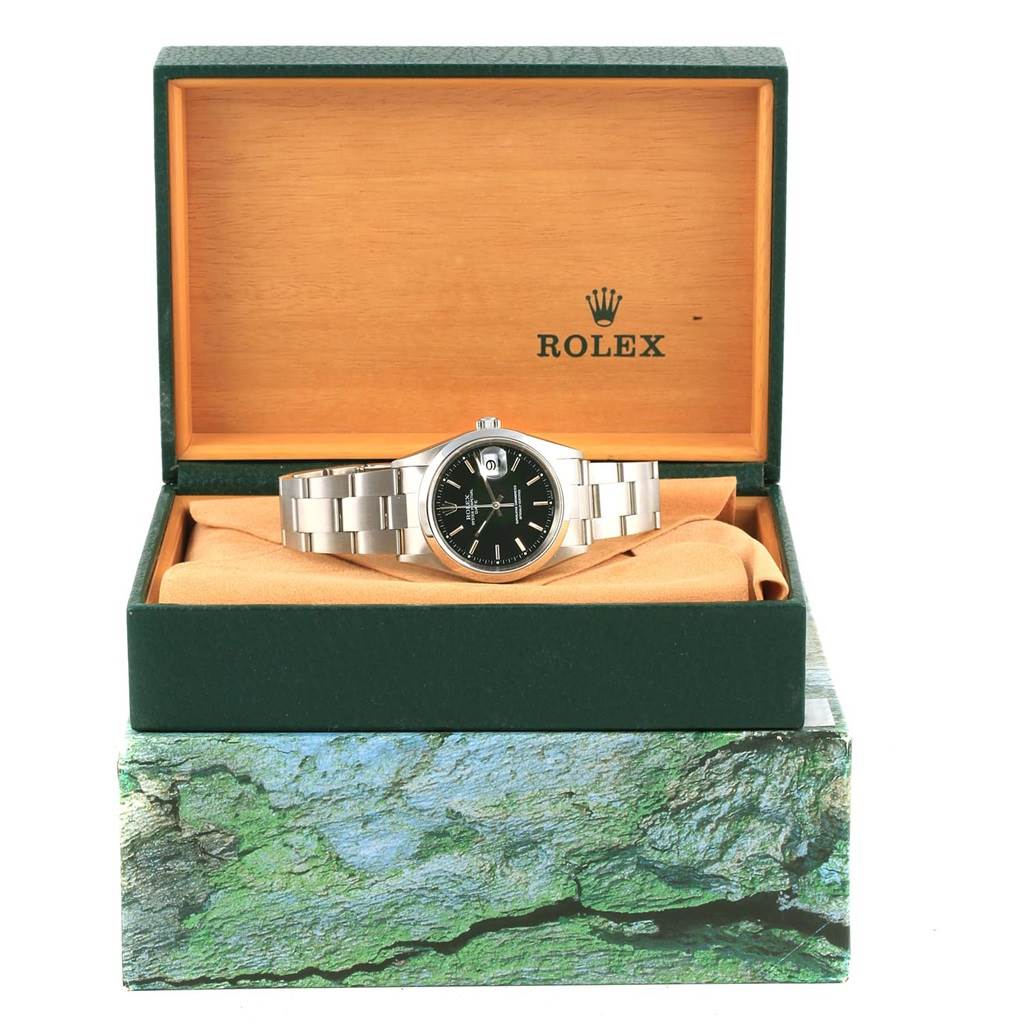 The Rolex Date 15200 Men's Stainless Steel Black Dial 15200 Men's Stainless Steel Black Dial model watch is displayed front-on in its open box, showing the dial, bracelet, and part of the packaging.
