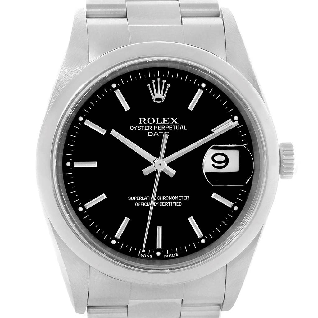 The image shows a front view of a Rolex Oyster Perpetual Date watch, emphasizing its black dial, date window, and stainless steel bracelet.