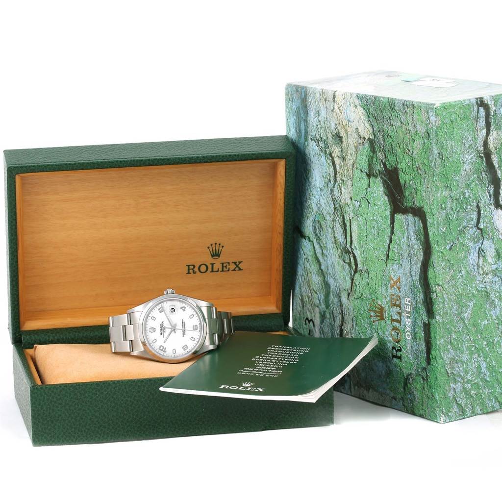 The image shows a Rolex Date 15200 Men's Stainless Steel White Dial 15200 Men's Stainless Steel White Dial model watch in its open green and wood box, with accompanying booklet and outer packaging.