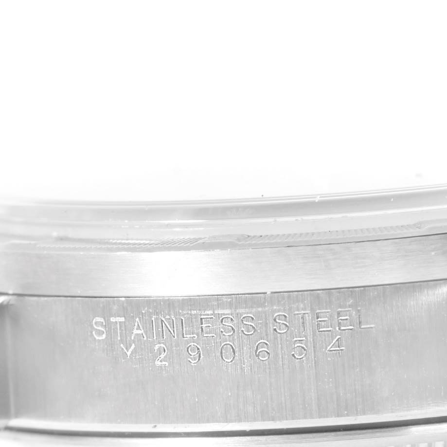 This close-up image shows the serial number and part of the case of a Rolex Date 15210 Men's Stainless Steel Silver Dial 15210 Men's Stainless Steel Silver Dial model watch.