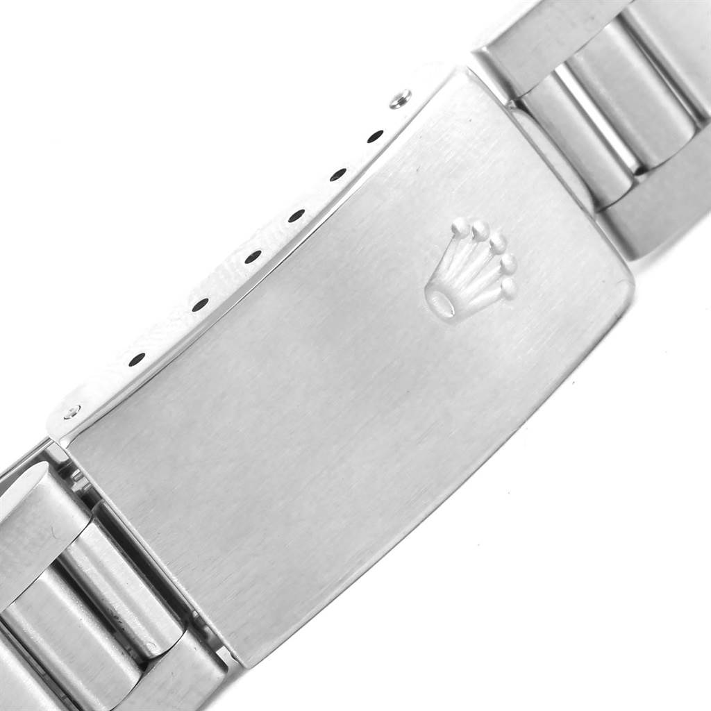 The image shows a close-up of the clasp of a Rolex Date 15210 Men's Stainless Steel Black Dial 15210 Men's Stainless Steel Black Dial model watch with the Rolex logo engraved on it.