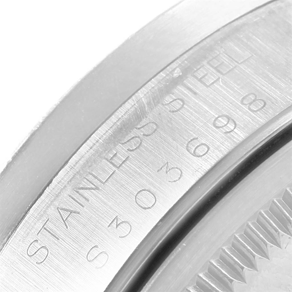 This close-up image shows the engraved serial number on the stainless steel case of a Rolex Date 15210 Men's Stainless Steel Black Dial 15210 Men's Stainless Steel Black Dial model watch.