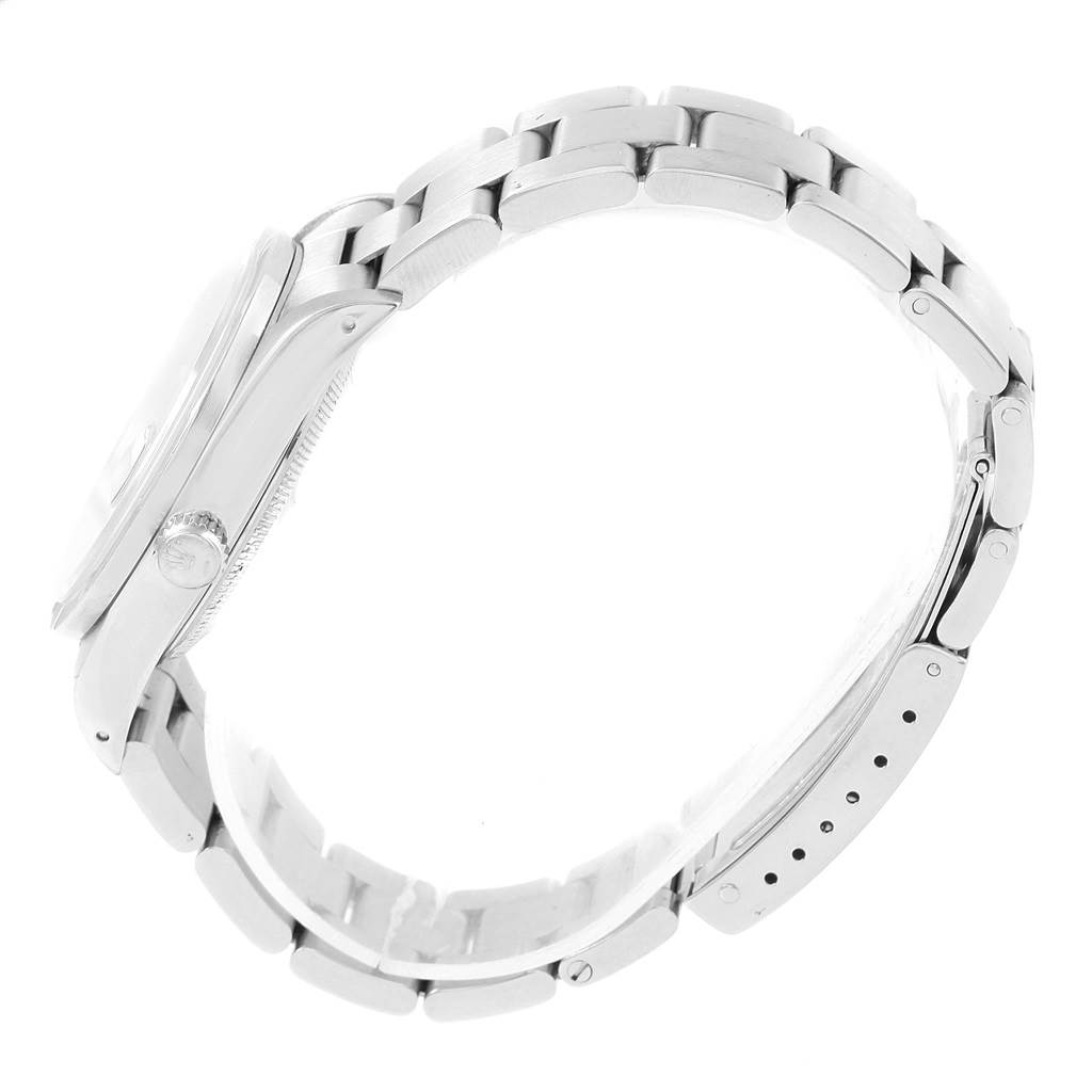 The image shows the side view of a Rolex Date 15210 Men's Stainless Steel Black Dial 15210 Men's Stainless Steel Black Dial model watch, highlighting its case, crown, and bracelet.