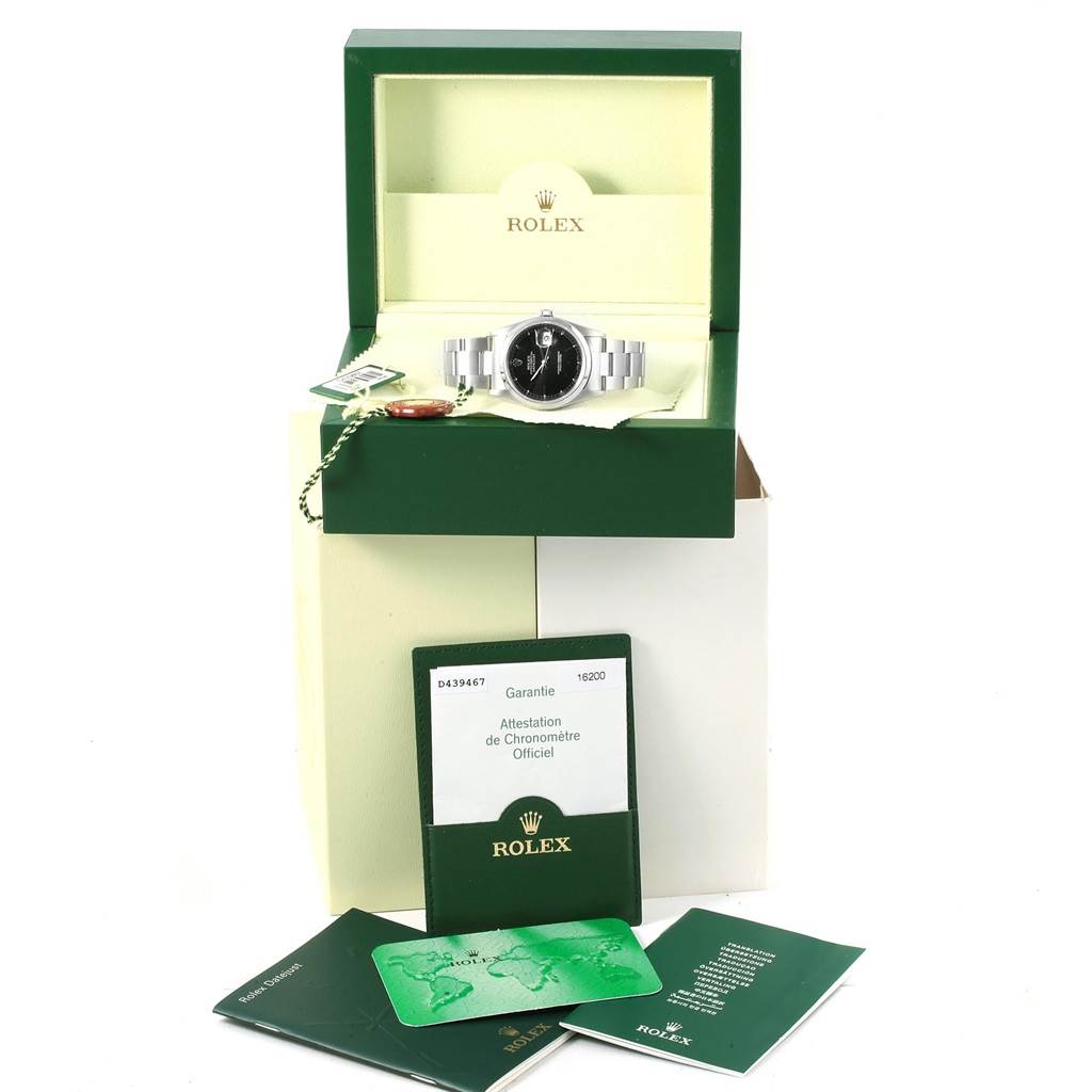 The image shows a Rolex Date 16200 Men's Stainless Steel Black Dial 16200 Men's Stainless Steel Black Dial model watch in its open box, with accompanying documents and accessories displayed.
