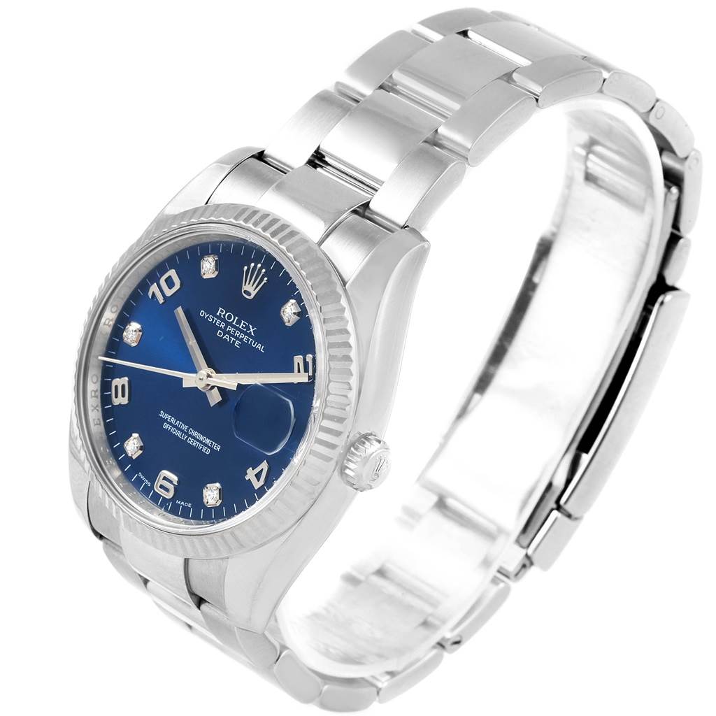 The Rolex Date 115234 Stainless Steel Blue Dial 115234 Stainless Steel Blue Dial watch is shown from a left-side angle, displaying the face, bezel, case, and bracelet.