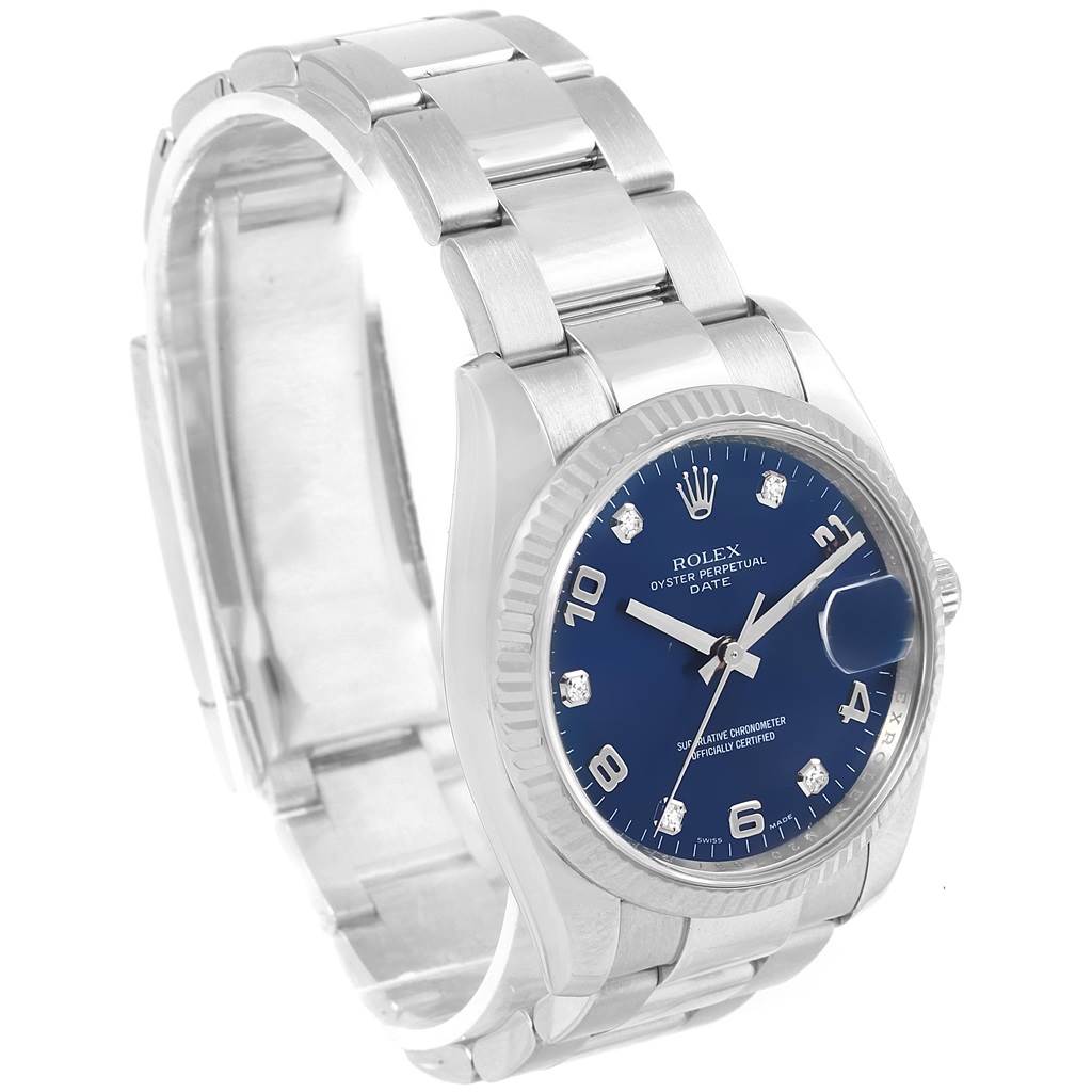The image shows a Rolex Date 115234 Stainless Steel Blue Dial 115234 Stainless Steel Blue Dial model wristwatch angled to the front left, highlighting the blue dial, bracelet, and part of the clasp.