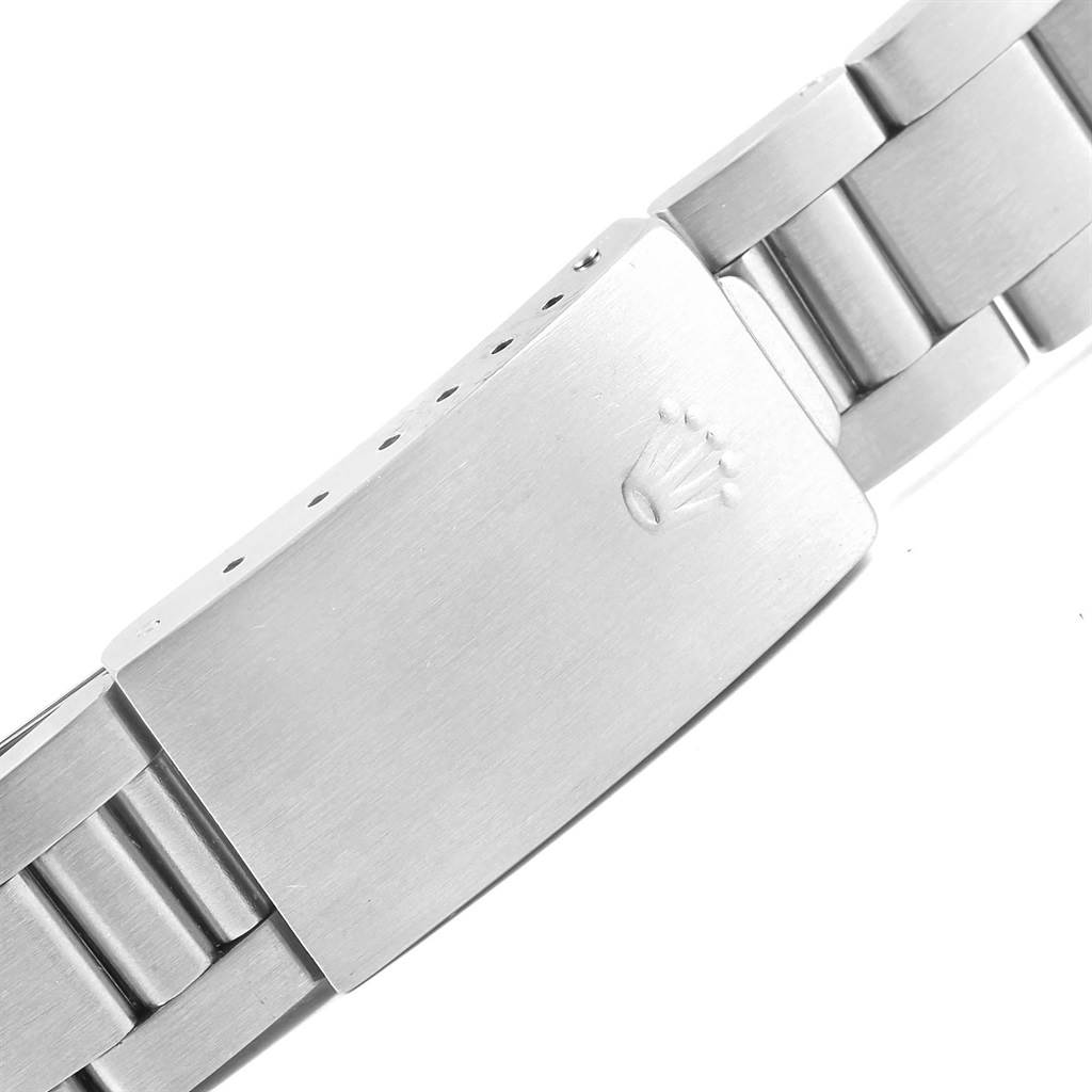 This image shows the clasp and part of the metal bracelet of the Date model by Rolex, viewed from the side.