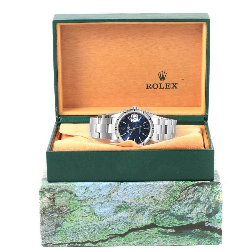 The Rolex Date 15210 Men's Stainless Steel Blue Dial 15210 Men's Stainless Steel Blue Dial model watch is shown in its open green box revealing the face and bracelet.