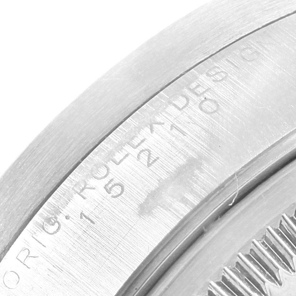 The image shows a close-up of the side and engraved bezel of a Rolex Date 15210 Men's Stainless Steel Blue Dial 15210 Men's Stainless Steel Blue Dial model watch.