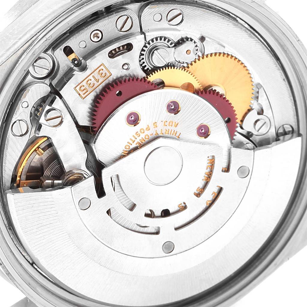 The image shows a close-up view of the internal mechanism of a Rolex Date 15210 Men's Stainless Steel Blue Dial 15210 Men's Stainless Steel Blue Dial model watch, highlighting gears and the rotor.