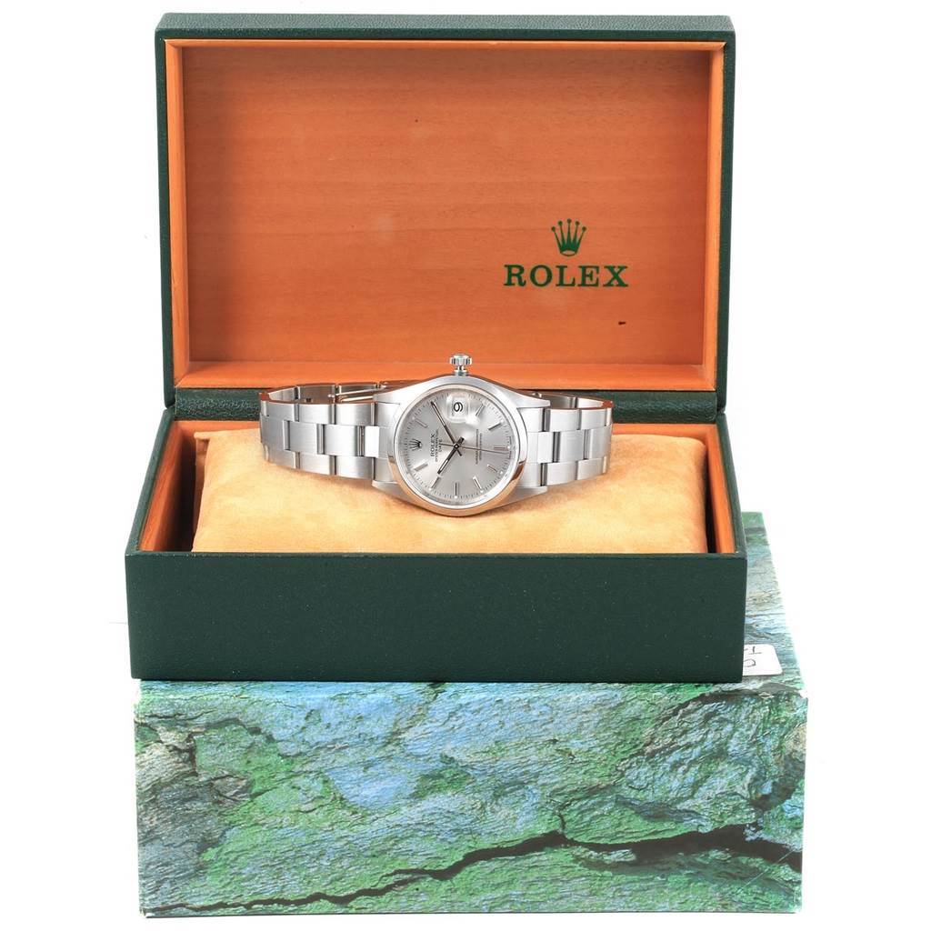The image shows a front view of a Rolex Date 15200 Men's Stainless Steel Silver Dial 15200 Men's Stainless Steel Silver Dial model watch in its open green and orange box.