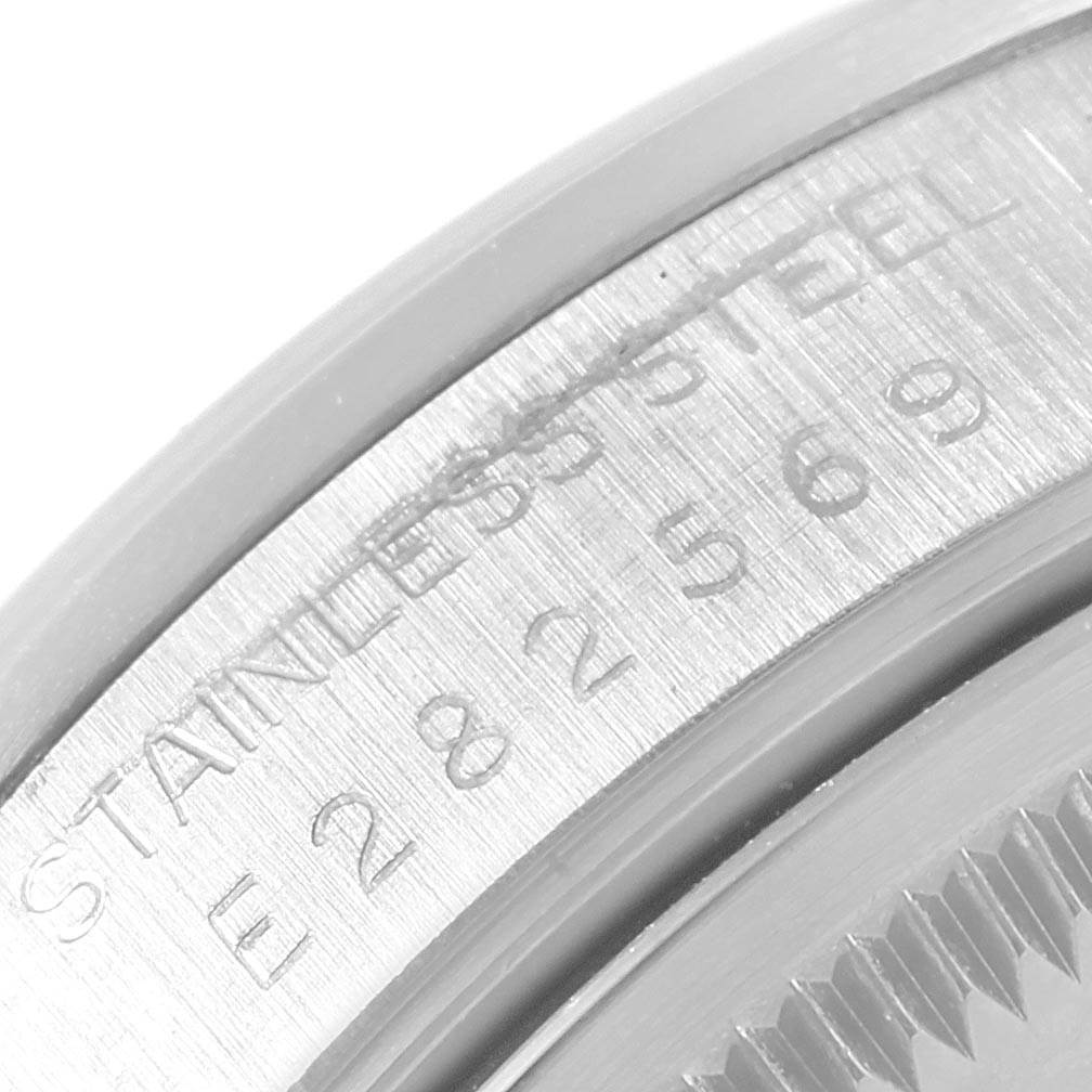 This image shows a close-up of the serial number and "STAINLESS STEEL" engraving on the case of a Rolex Date 15200 Men's Stainless Steel White Dial 15200 Men's Stainless Steel White Dial watch.