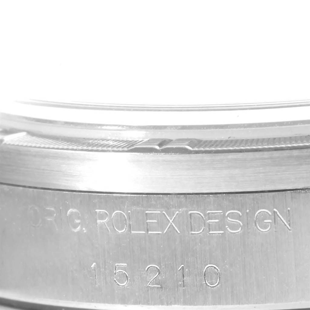 The image shows a close-up of the serial number and engraving on the case of a Rolex Date 15210 Men's Stainless Steel Blue Dial 15210 Men's Stainless Steel Blue Dial model watch.