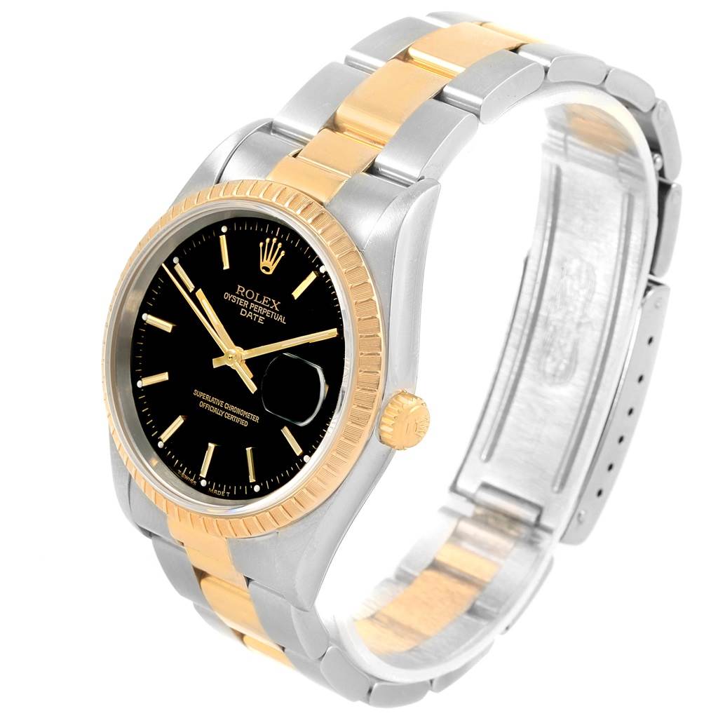 The image shows a Rolex Date 15223 Men's Steel and Gold (two tone) Black Dial 15223 Men's Steel and Gold (two tone) Black Dial watch at a tilted angle, highlighting its black dial, gold bezel, and two-tone bracelet.