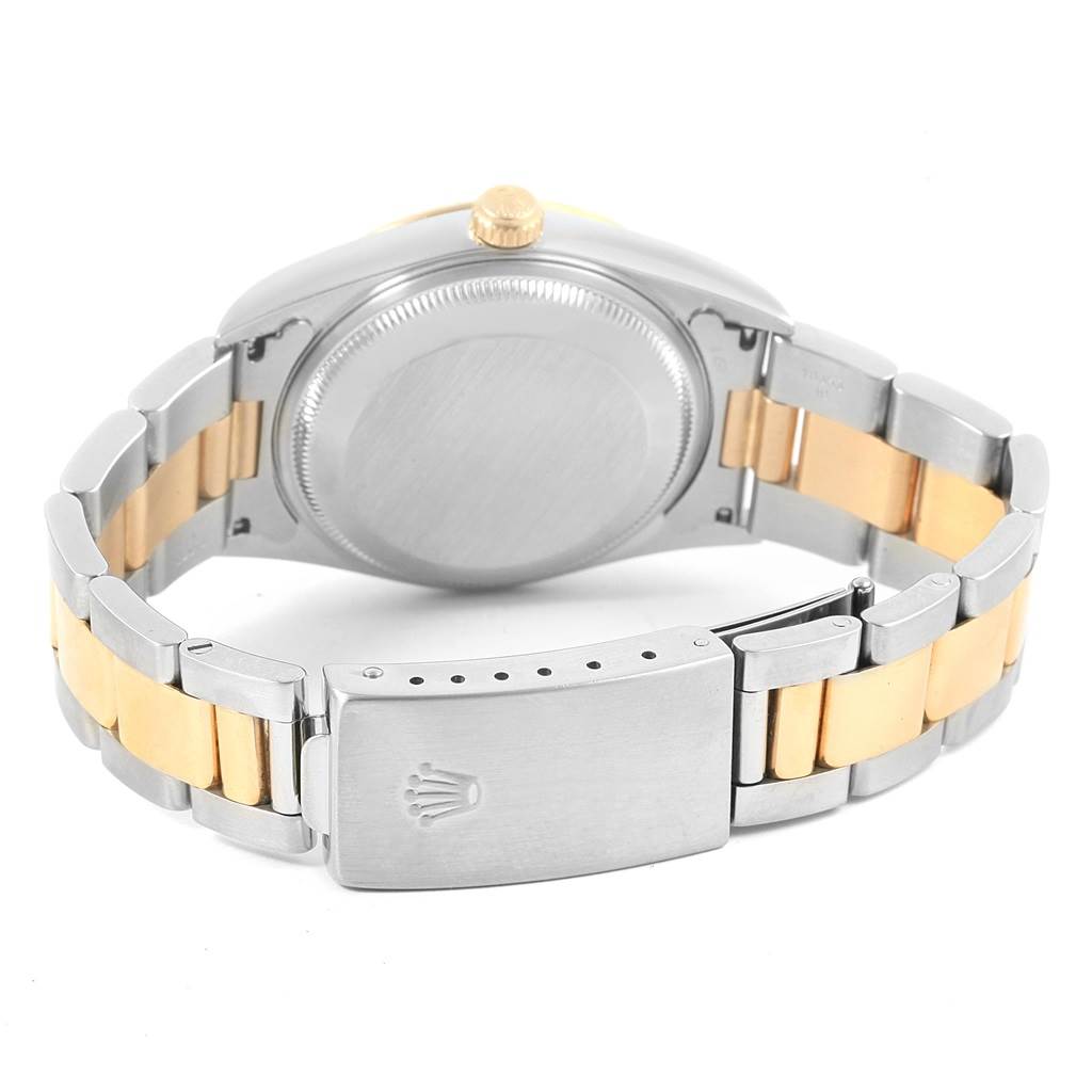 This image shows the back case and bracelet of a Rolex Date 15223 Men's Steel and Gold (two tone) Black Dial 15223 Men's Steel and Gold (two tone) Black Dial watch including its clasp and crown.