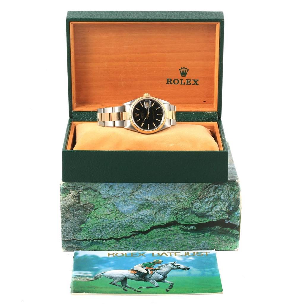 The image shows a Rolex Date 15223 Men's Steel and Gold (two tone) Black Dial 15223 Men's Steel and Gold (two tone) Black Dial model watch in an open display box, with a booklet in front.