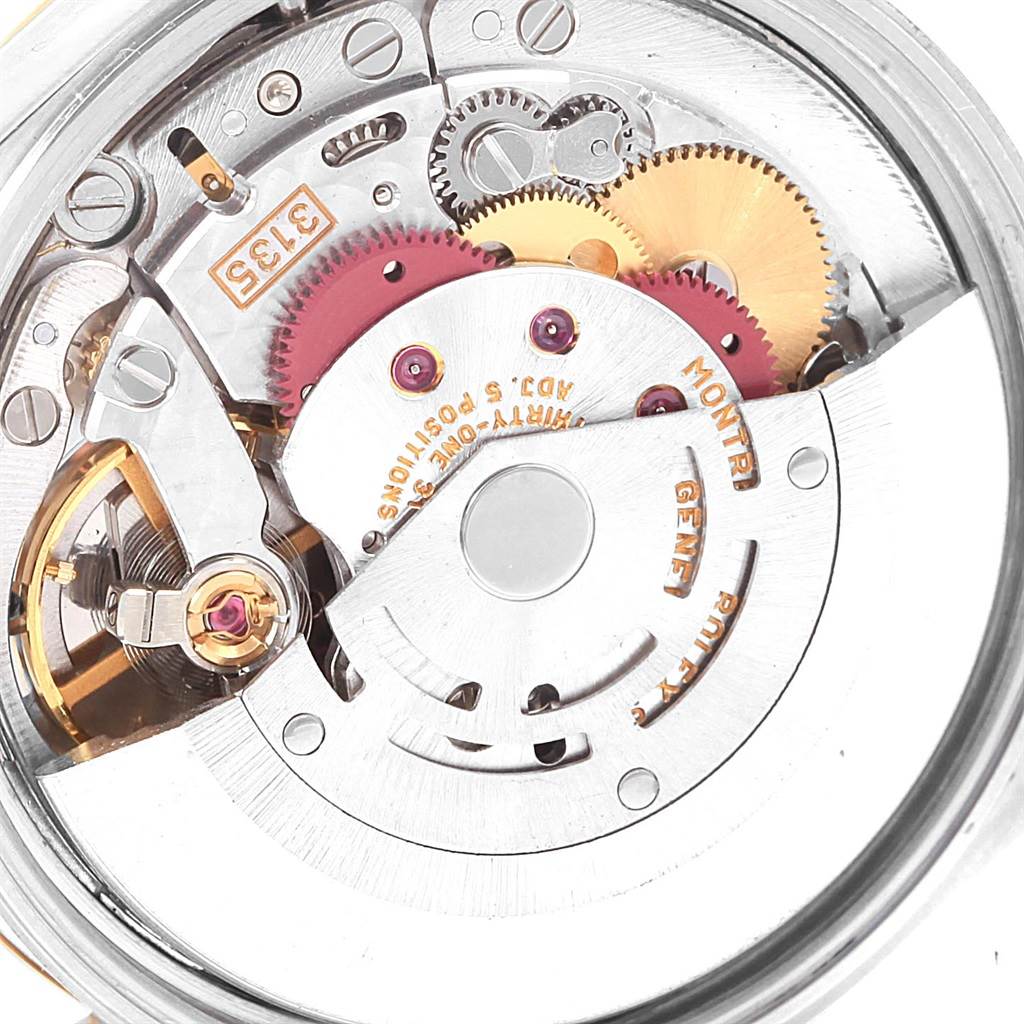 The image shows a close-up view of the inner workings of a Rolex Date 15223 Men's Steel and Gold (two tone) White Dial 15223 Men's Steel and Gold (two tone) White Dial model watch, highlighting its gears and mechanical components.