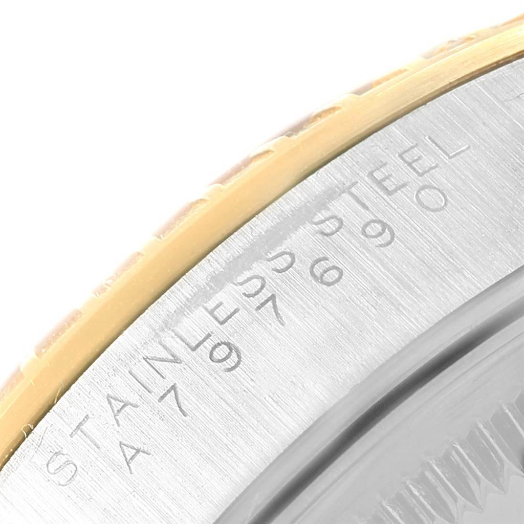 The image shows a close-up view of the Rolex Date 15223 Men's Steel and Gold (two tone) White Dial 15223 Men's Steel and Gold (two tone) White Dial model's stainless steel casing with the serial number engraved.